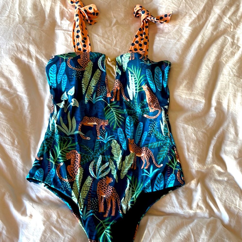 One piece with tropical print new never worn with pad. Runs small XL with mesh